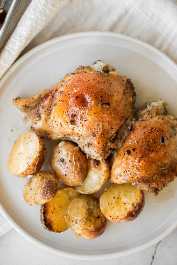 One pan garlic roasted chicken and baby potatoes is an easy to make, delicious, and wholesome meal for the entire family. Prep this sheet pan in 10 minutes. | aheadofthyme.com