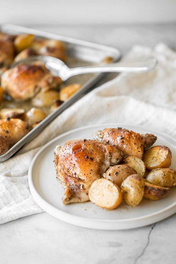 One pan garlic roasted chicken and baby potatoes is an easy to make, delicious, and wholesome meal for the entire family. Prep this sheet pan in 10 minutes. | aheadofthyme.com