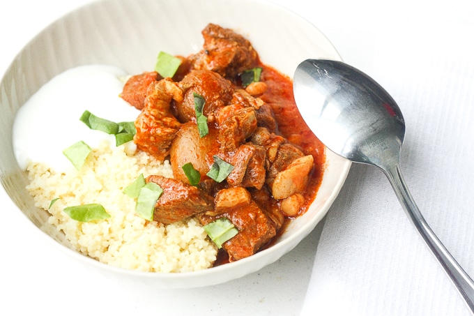 A bowl of flavourful and tender, juicy slow cooker Moroccan lamb stew served over a bowl of couscous is the ultimate Middle Eastern comfort food. | aheadofthyme.com