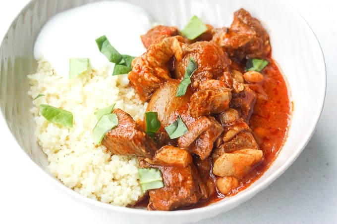 A bowl of flavourful and tender, juicy slow cooker Moroccan lamb stew served over a bowl of couscous is the ultimate Middle Eastern comfort food. | aheadofthyme.com