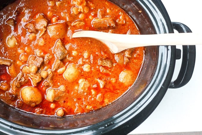 A bowl of flavourful and tender, juicy slow cooker Moroccan lamb stew served over a bowl of couscous is the ultimate Middle Eastern comfort food. | aheadofthyme.com