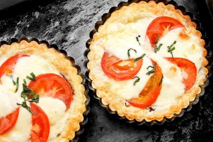 Looking for the perfect appetizer or light lunch? Try a tomato and mozzarella tart topped with basil and a drizzle of pomegranate molasses! | aheadofthyme.com