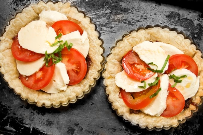 Looking for the perfect appetizer or light lunch? Try a tomato and mozzarella tart topped with basil and a drizzle of pomegranate molasses! | aheadofthyme.com