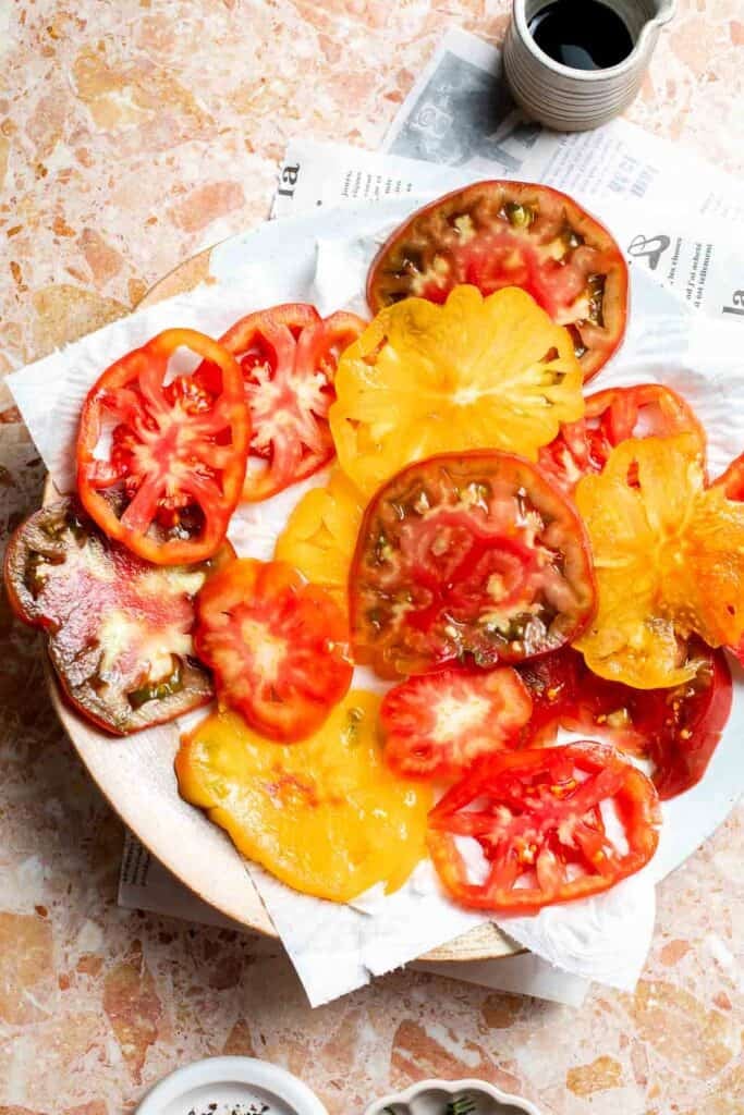 Sliced tomatoes sprinkled with salt to remove excess moisture.