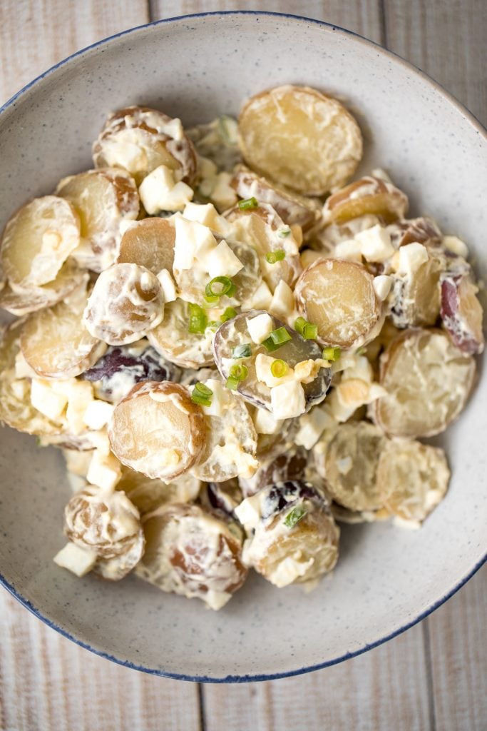 Easy homemade potato salad is loaded with baby potatoes, eggs, and green onions and tossed in a mayo sauce and is a go-to for summer barbecues and picnics. | aheadofthyme.com