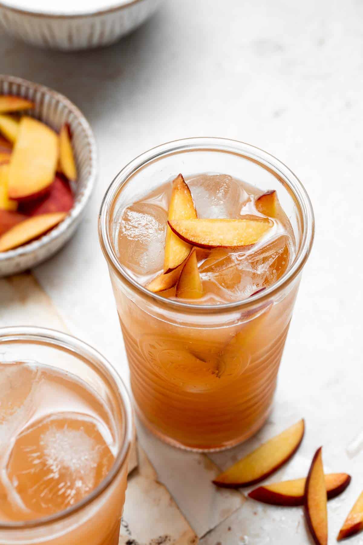 Homemade peach iced tea is healthy summer drink — refreshing, peachy, sweet, and perfect. It's loaded with real fruit and vitamins and easy to make. | aheadofthyme.com
