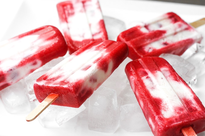 It is time to say good-bye to the store-bought stuff and make skinny strawberries and cream popsicles at home using fresh fruit and Greek yogurt! | aheadofthyme.com