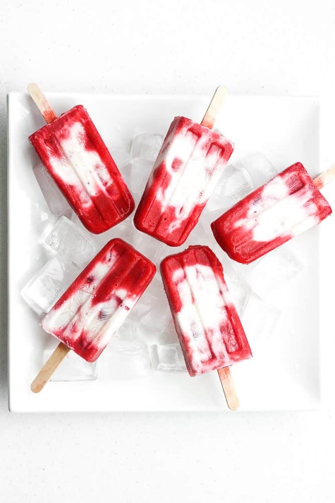 It is time to say good-bye to the store-bought stuff and make skinny strawberries and cream popsicles at home using fresh fruit and Greek yogurt! | aheadofthyme.com