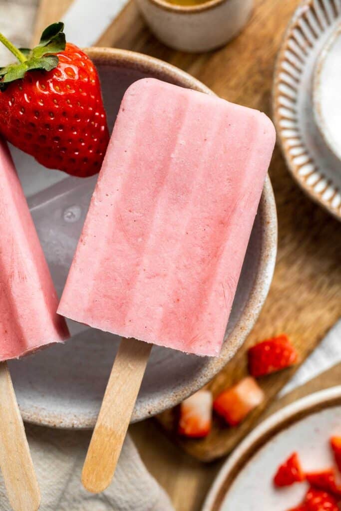 Homemade Strawberries and Cream Popsicles are healthy and easy to make using just four ingredients including fresh fruit. | aheadofthyme.com