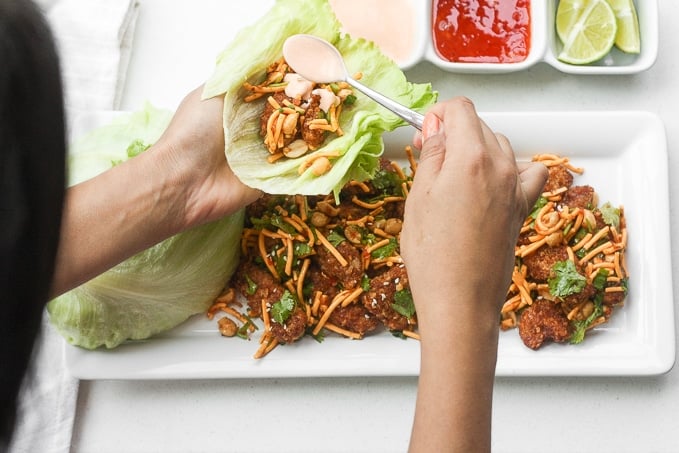 Spice it up and make copycat Szechuan chicken lettuce wraps with spicy mayo from the comfort of your own home with this easy to follow recipe. Plus, it is healthier than the original! | aheadofthyme.com