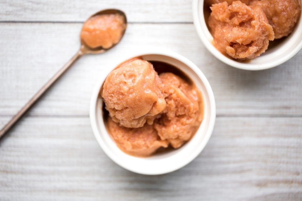 Smooth, sweet and refreshing 3-ingredient peach sorbet can be made with just a few minutes prep and without an ice cream maker! It's dairy-free and vegan. | aheadofthyme.com