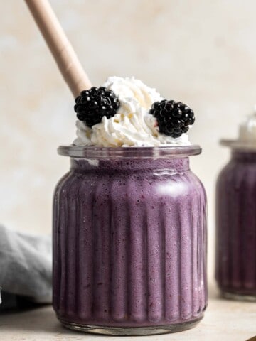 This blackberry milkshake is thick, creamy, and smooth. You won’t believe how quick and easy it is to make at home with 3 ingredients in under 5 minutes. | aheadofthyme.com