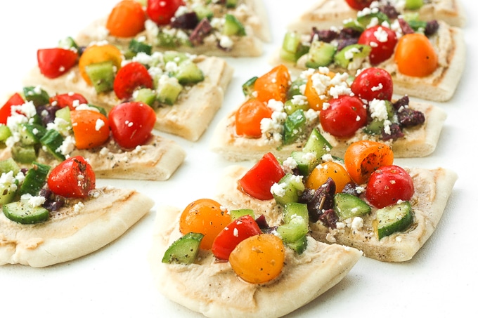This bright and colourful Greek salad hummus flatbread is perfect as an appetizer or a healthy lunch or snack. | aheadofthyme.com