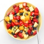 Celebrate summer with this go to, simple and colourful summer fruit salad! Just toss a handful of fruits together in a honey lemon dressing and dig in! | aheadofthyme.com