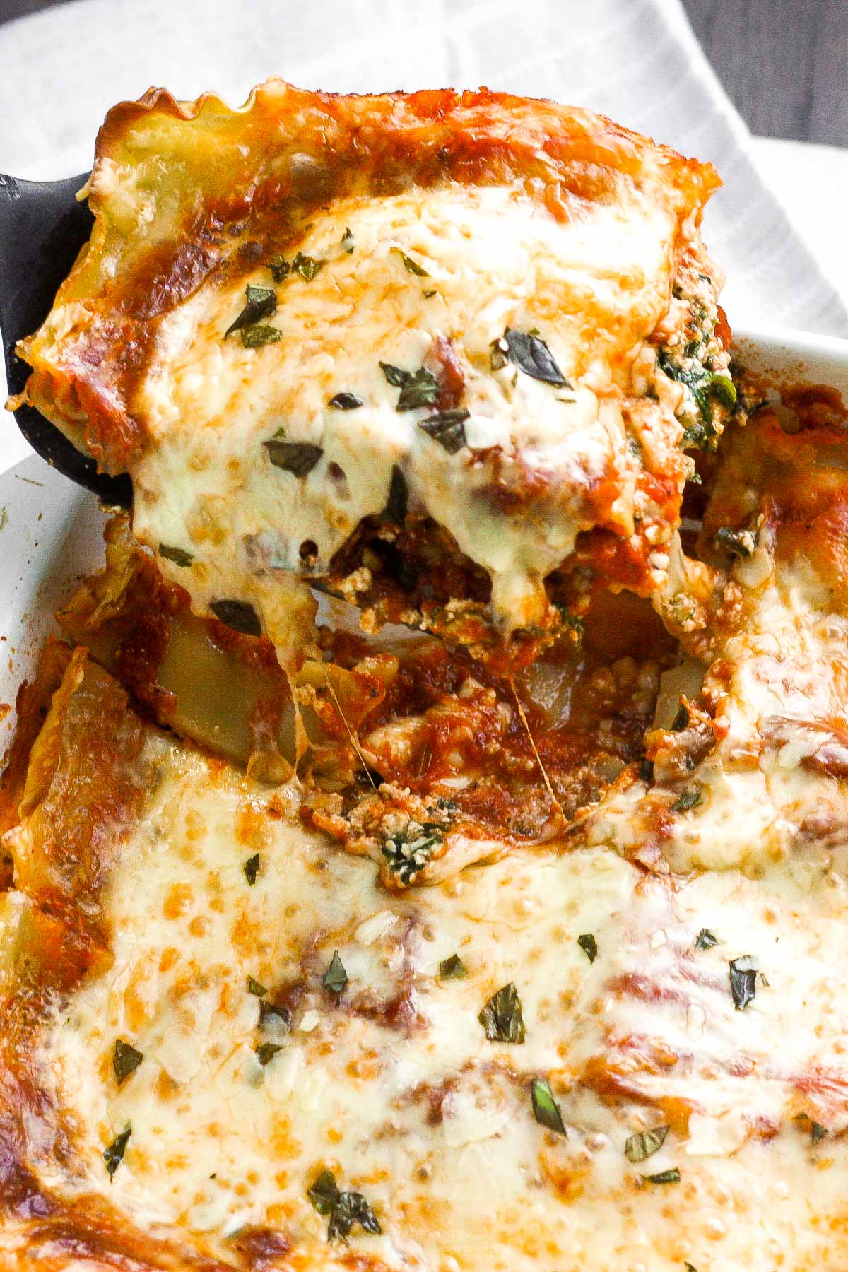 Take comfort food to another level with the best creamy spinach and tomato vegetarian lasagna. You won't even miss the meat! | aheadofthyme.com