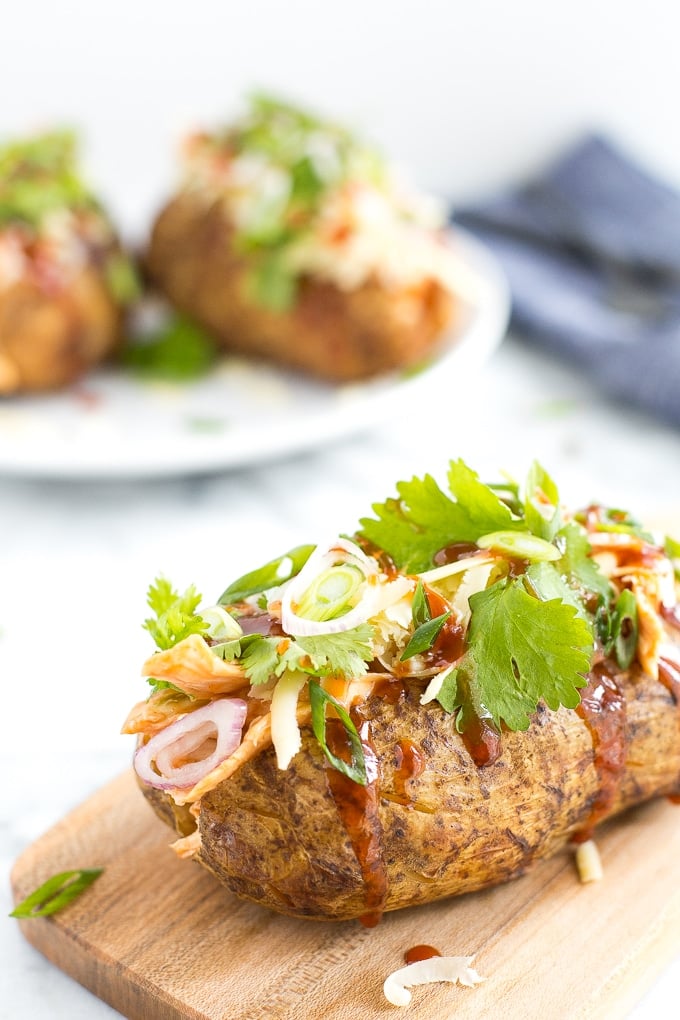 Try this gorgeous combination of BBQ chicken, scallions, cilantro and gruyere for an explosion of flavour in loaded BBQ chicken stuffed baked potatoes! | aheadofthyme.com