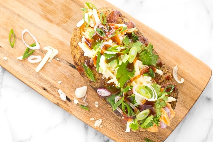 Try this gorgeous combination of BBQ chicken, scallions, cilantro and gruyere for an explosion of flavour in loaded BBQ chicken stuffed baked potatoes! | aheadofthyme.com