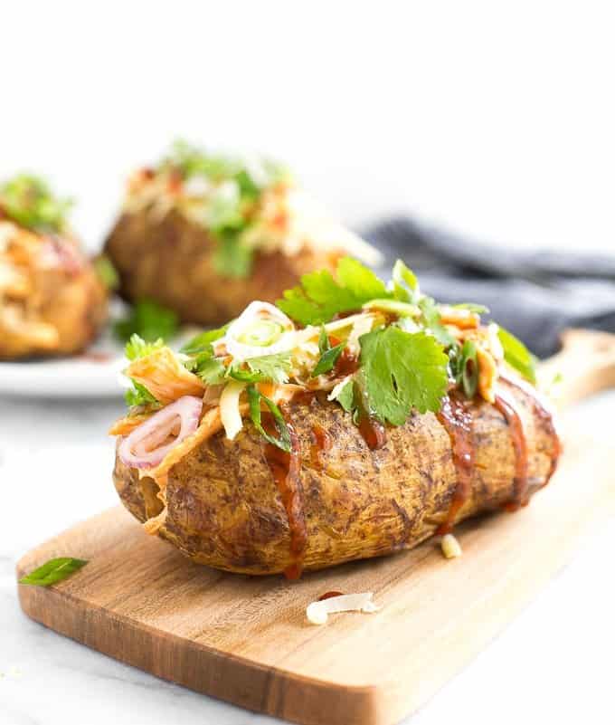 Try this gorgeous combination of BBQ chicken, scallions, cilantro and gruyere for an explosion of flavour in loaded BBQ chicken stuffed baked potatoes! | aheadofthyme.com