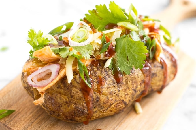 Try this gorgeous combination of BBQ chicken, scallions, cilantro and gruyere for an explosion of flavour in loaded BBQ chicken stuffed baked potatoes! | aheadofthyme.com