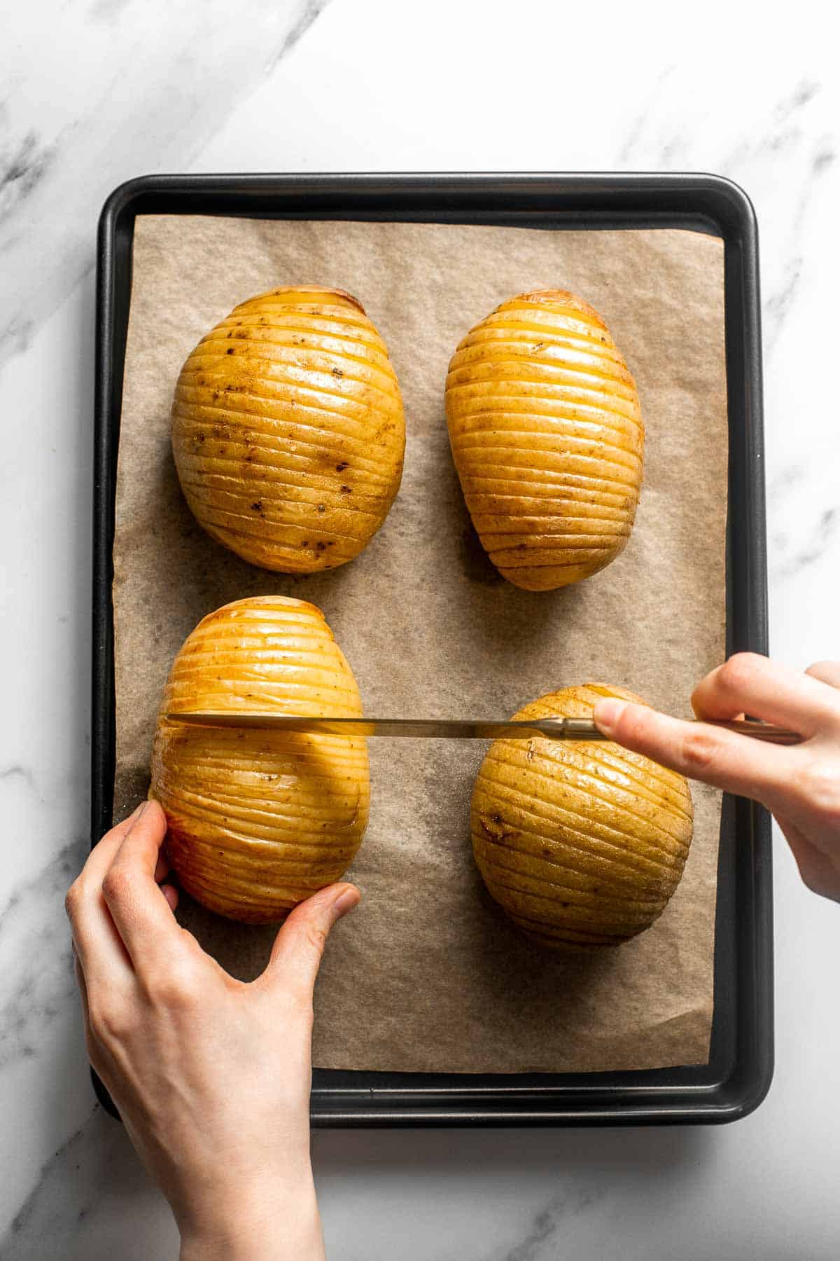 Hasselback Potatoes are infused with garlic butter and feature signature cuts that make these potatoes crispy on the outside and tender on the inside. | aheadofthyme.com