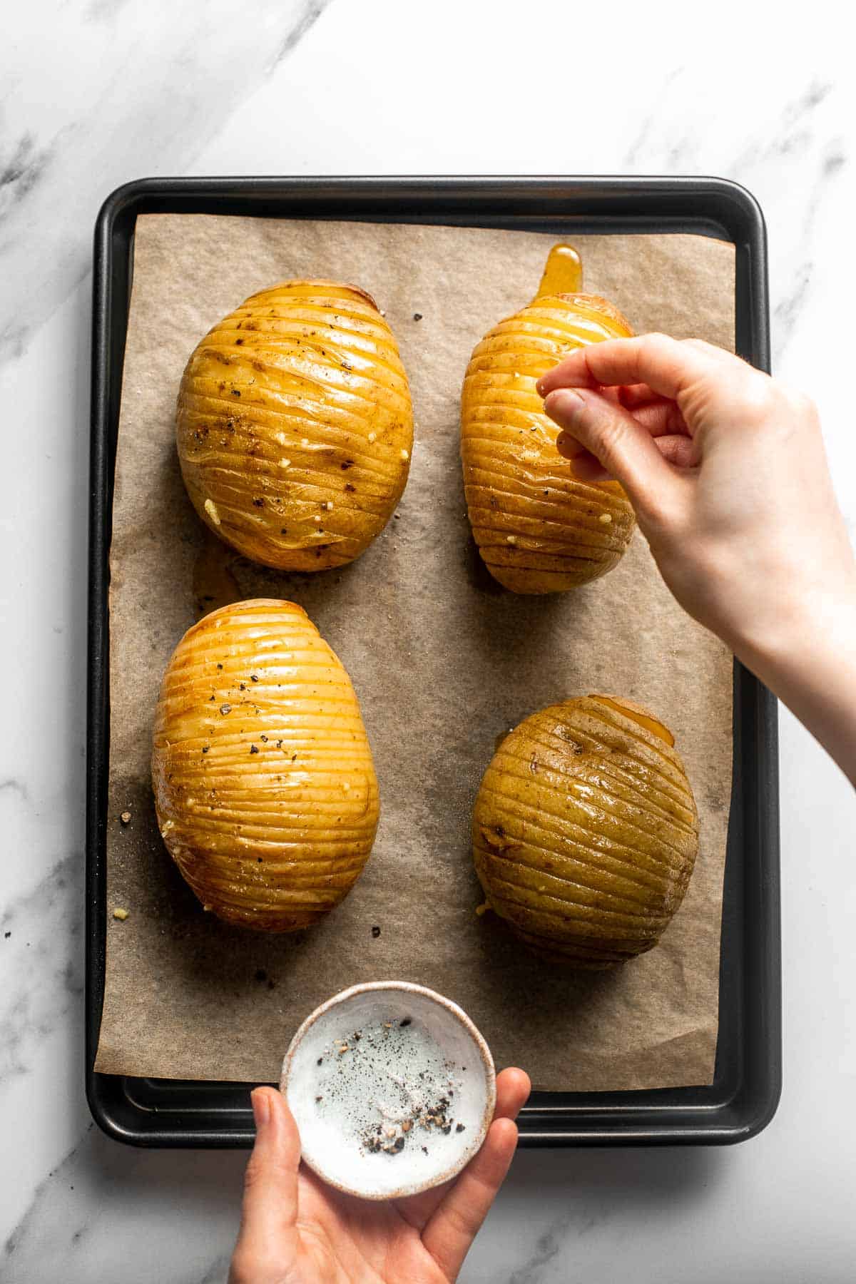 Hasselback Potatoes are infused with garlic butter and feature signature cuts that make these potatoes crispy on the outside and tender on the inside. | aheadofthyme.com