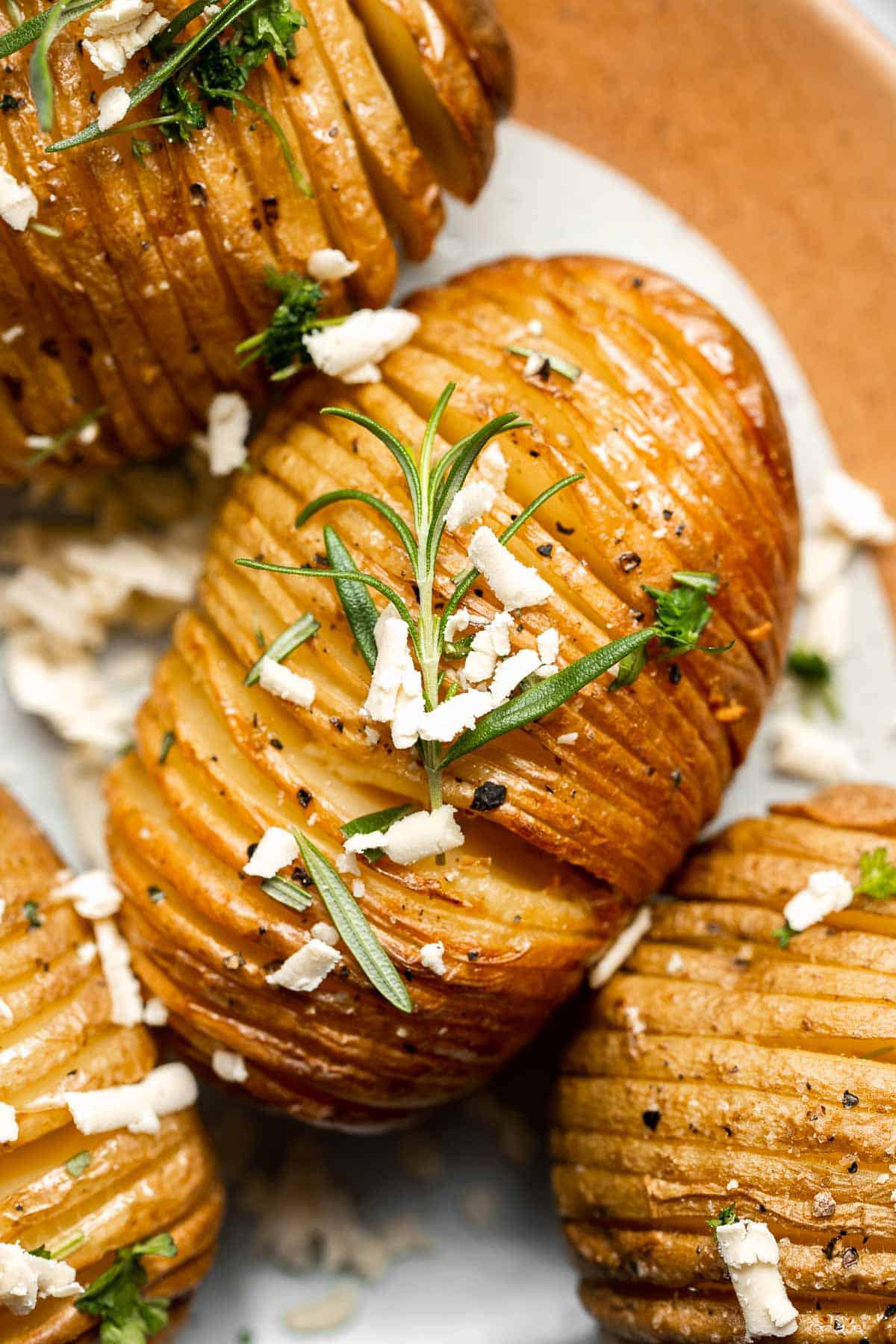 Hasselback Potatoes are infused with garlic butter and feature signature cuts that make these potatoes crispy on the outside and tender on the inside. | aheadofthyme.com