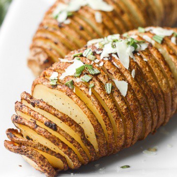 Hasselback potatoes with garlic herb butter are perfectly crispy on the outside and tender and buttery on the inside, infused with garlic and rosemary. | aheadofthyme.com