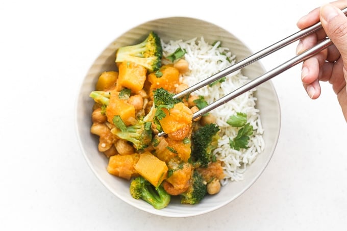 Warm yourself up this fall with a big bowl of comforting pumpkin chickpea coconut curry with cashews. This curry is also vegan and gluten-free! | aheadofthyme.com