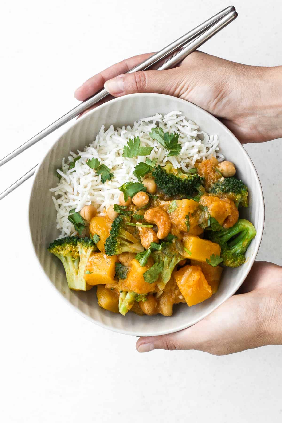 Warm yourself up this fall with a big bowl of comforting pumpkin chickpea coconut curry with cashews. This curry is also vegan and gluten-free! | aheadofthyme.com