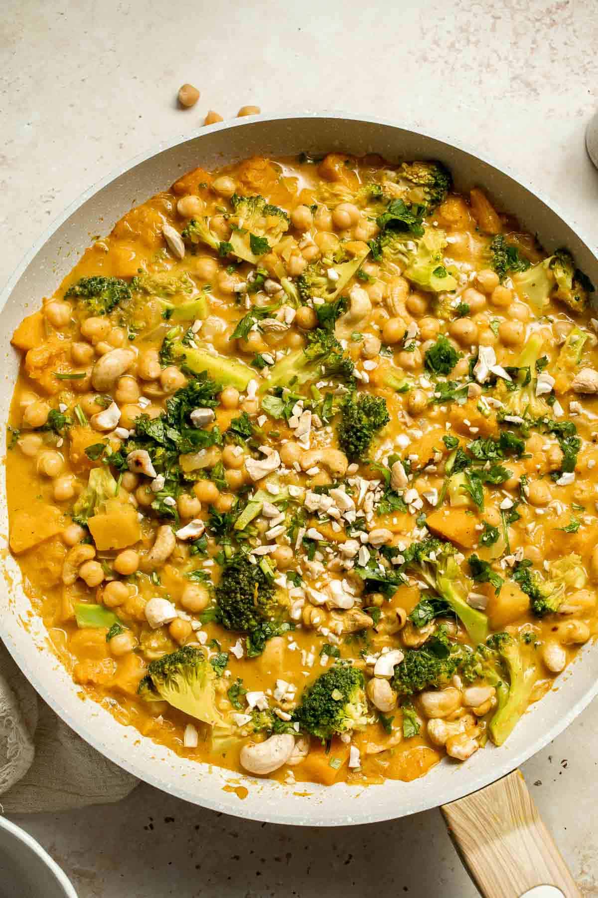 Creamy Pumpkin Curry is made with fresh pumpkin, chickpeas, broccoli, and cashews in a fragrant red coconut curry sauce. It's vegan and gluten-free too! | aheadofthyme.com