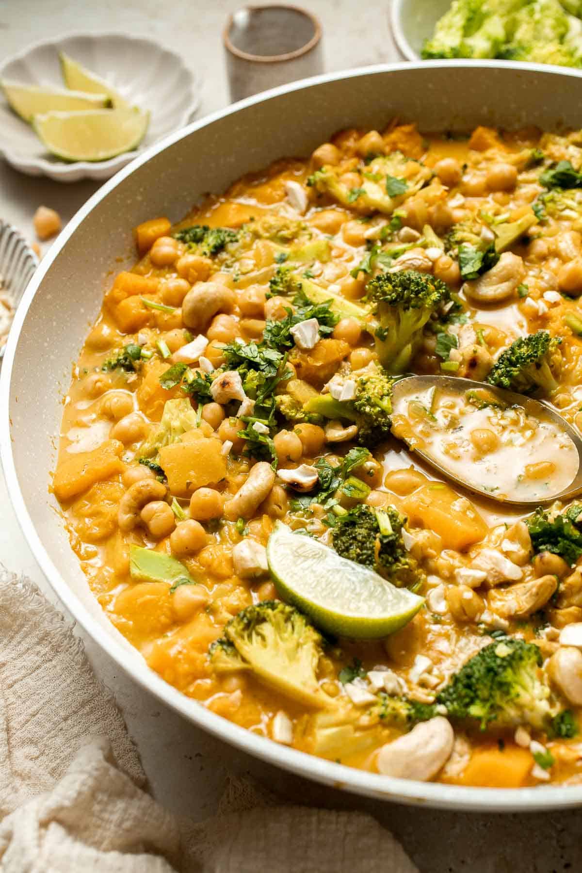 Creamy Pumpkin Curry is made with fresh pumpkin, chickpeas, broccoli, and cashews in a fragrant red coconut curry sauce. It's vegan and gluten-free too! | aheadofthyme.com