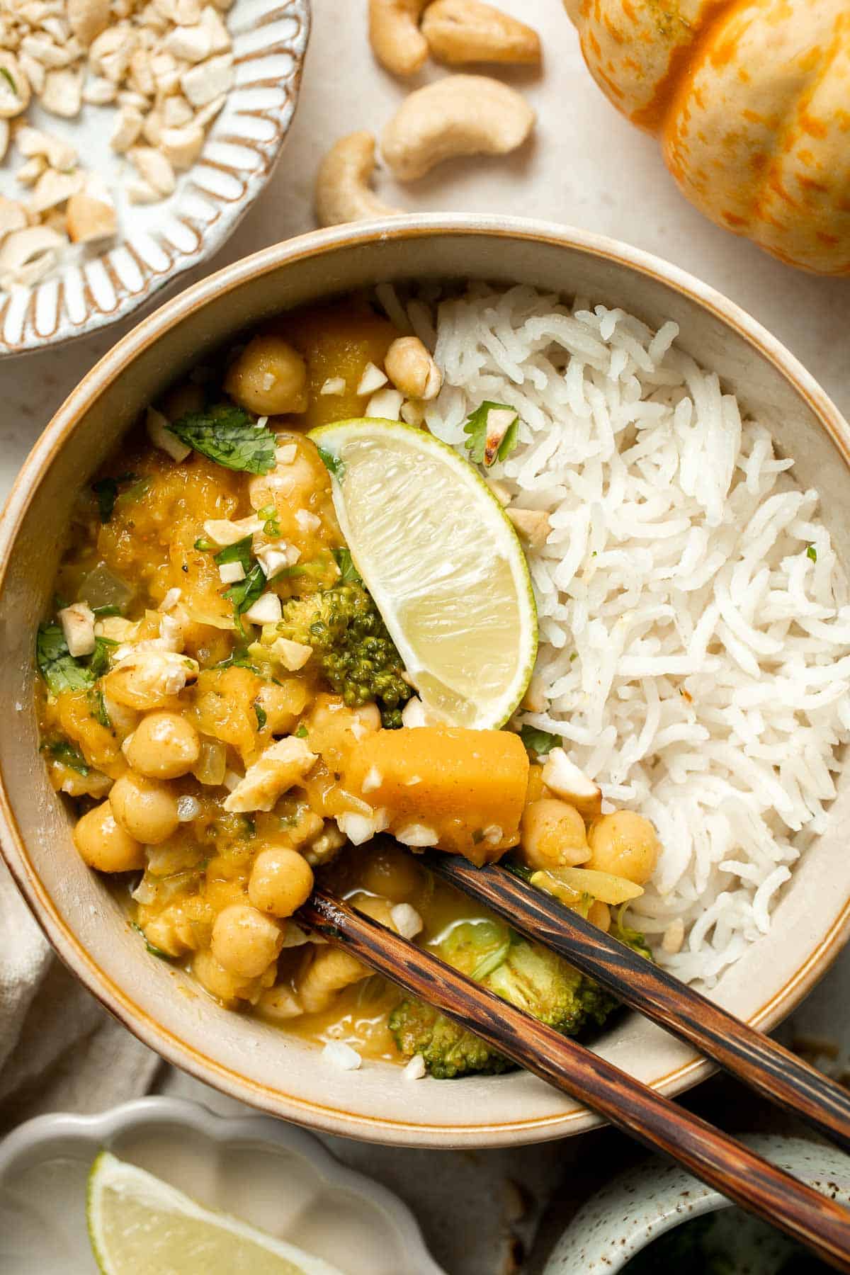 Creamy Pumpkin Curry is made with fresh pumpkin, chickpeas, broccoli, and cashews in a fragrant red coconut curry sauce. It's vegan and gluten-free too! | aheadofthyme.com