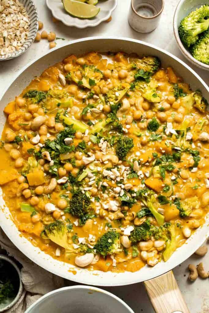 Creamy Pumpkin Curry is made with fresh pumpkin, chickpeas, broccoli, and cashews in a fragrant red coconut curry sauce. It's vegan and gluten-free too! | aheadofthyme.com