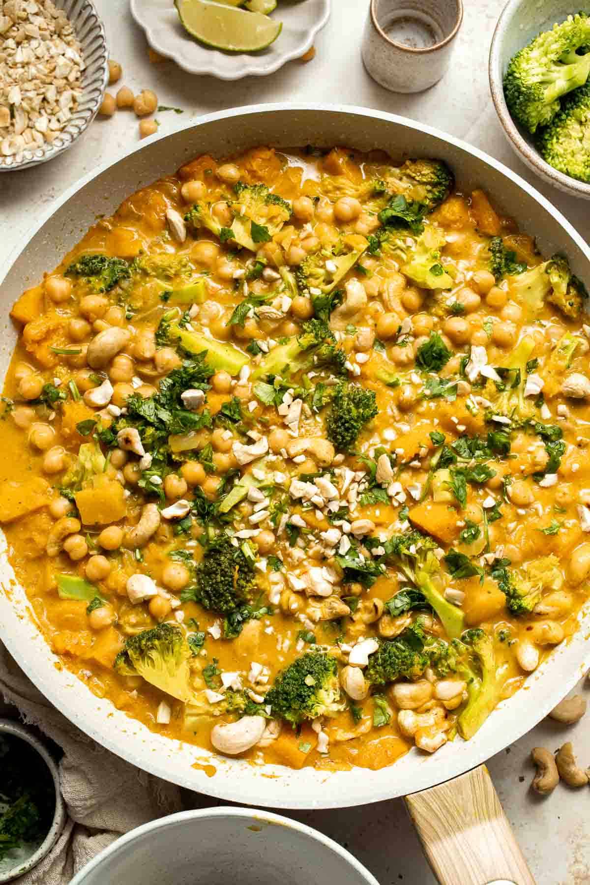 Creamy Pumpkin Curry is made with fresh pumpkin, chickpeas, broccoli, and cashews in a fragrant red coconut curry sauce. It's vegan and gluten-free too! | aheadofthyme.com