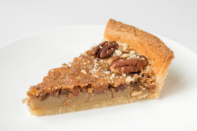 Give traditional pecan pie a twist this holiday season by using finely chopped pecans to create a smooth topping on this chopped pecan pie! | aheadofthyme.com