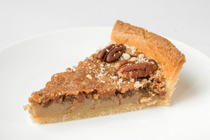 Give traditional pecan pie a twist this holiday season by using finely chopped pecans to create a smooth topping on this chopped pecan pie! | aheadofthyme.com