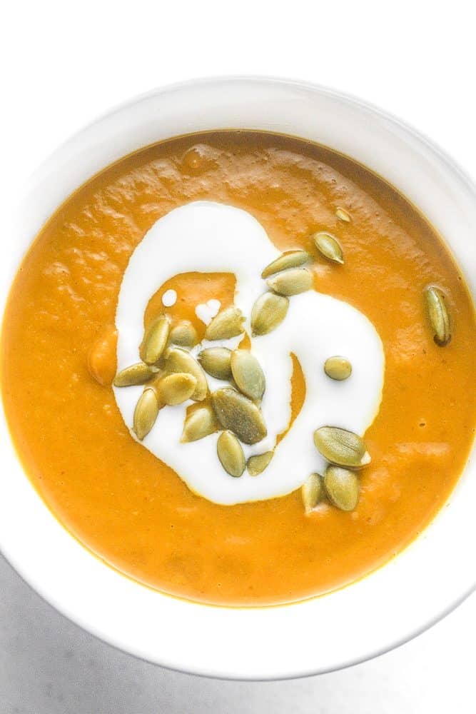 Coconut curry pumpkin soup is a bowl of comfort with a kick. This soup comes together in less than 30 minutes using a handful of ingredients! | aheadofthyme.com