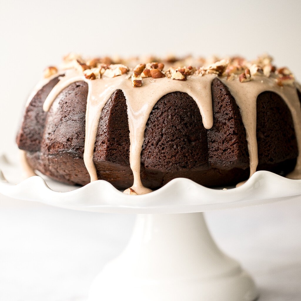 This showstopping festive gingerbread bundt cake with maple cinnamon glaze and pecans is moist, soft, and fluffy, and packed with warm holiday spices. | aheadofthyme.com