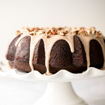 This showstopping festive gingerbread bundt cake with maple cinnamon glaze and pecans is moist, soft, and fluffy, and packed with warm holiday spices. | aheadofthyme.com