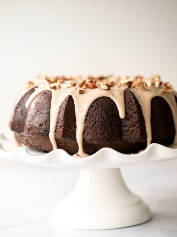 This showstopping festive gingerbread bundt cake with maple cinnamon glaze and pecans is moist, soft, and fluffy, and packed with warm holiday spices. | aheadofthyme.com