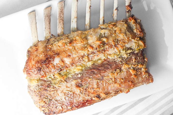 Ready in under 30 minutes, juicy and tender garlic rosemary rack of lamb is an exquisite dish bursting with incredible flavours in each and every bite. | aheadofthyme.com