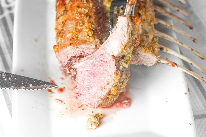 Ready in under 30 minutes, juicy and tender garlic rosemary rack of lamb is an exquisite dish bursting with incredible flavours in each and every bite. | aheadofthyme.com