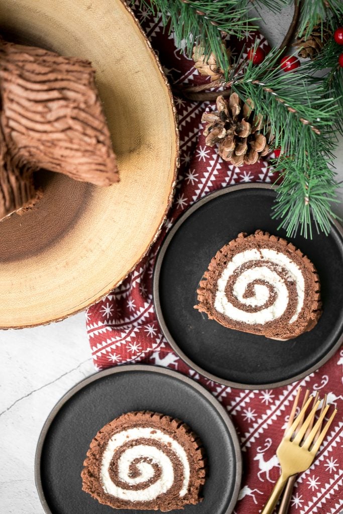 Holiday yule log cake (Bûche de Noël) with a chocolate sponge cake, whipped cream filling, and whipped chocolate ganache coating is a Christmas classic. | aheadofthyme.com