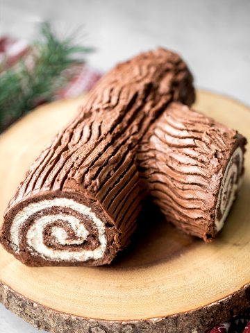 Holiday yule log cake (Bûche de Noël) with a chocolate sponge cake, whipped cream filling, and whipped chocolate ganache coating is a Christmas classic. | aheadofthyme.com