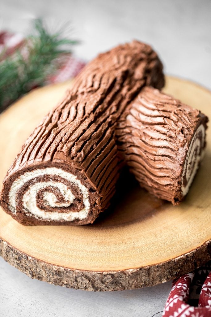 Holiday yule log cake (Bûche de Noël) with a chocolate sponge cake, whipped cream filling, and whipped chocolate ganache coating is a Christmas classic. | aheadofthyme.com