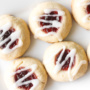 Soft, buttery, melt-in-your mouth jam-filled thumbprint cookies with almond glaze are the cutest, festive treat to make. | aheadofthyme.com