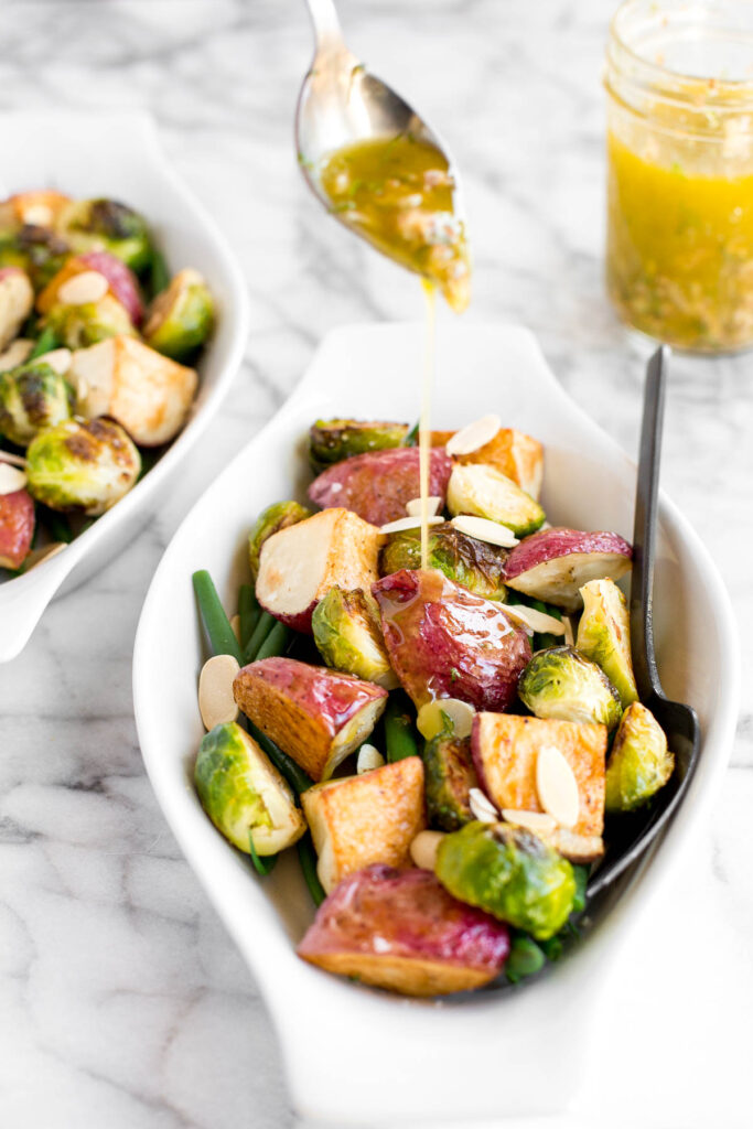 Roasted brussels sprouts salad with creamy potatoes, crispy string beans, tender brussels sprouts, is tossed in a delicious homemade dijon vinaigrette. | aheadofthyme.com