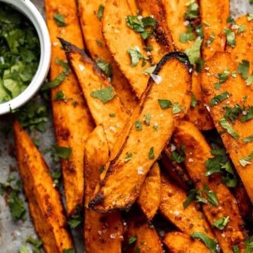 Baked Sweet Potato Wedges are crispy, delicious, flavorful. Serve as an appetizer or side dish. They are salty, savory, and sweet, with a hint of spice. | aheadofthyme.com