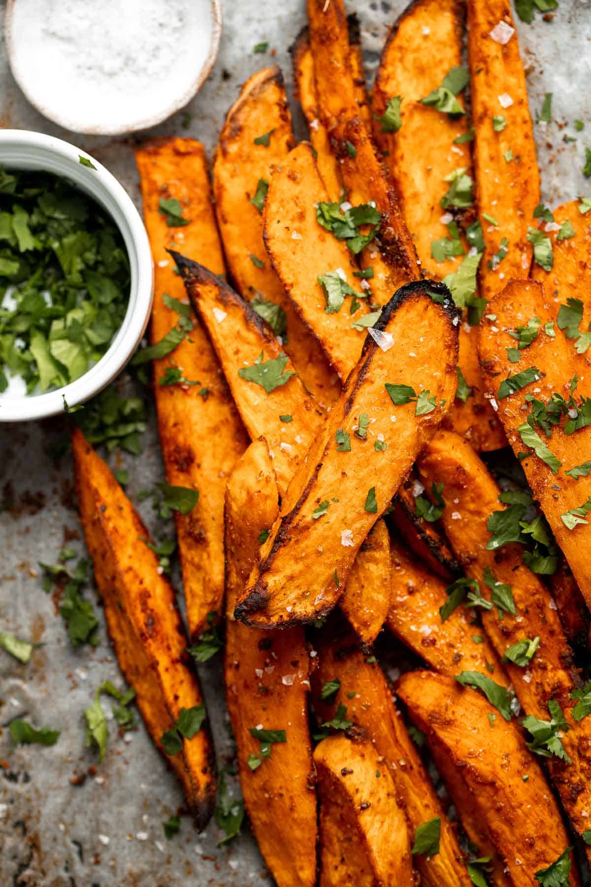 Baked Sweet Potato Wedges are crispy, delicious, flavorful. Serve as an appetizer or side dish. They are salty, savory, and sweet, with a hint of spice. | aheadofthyme.com