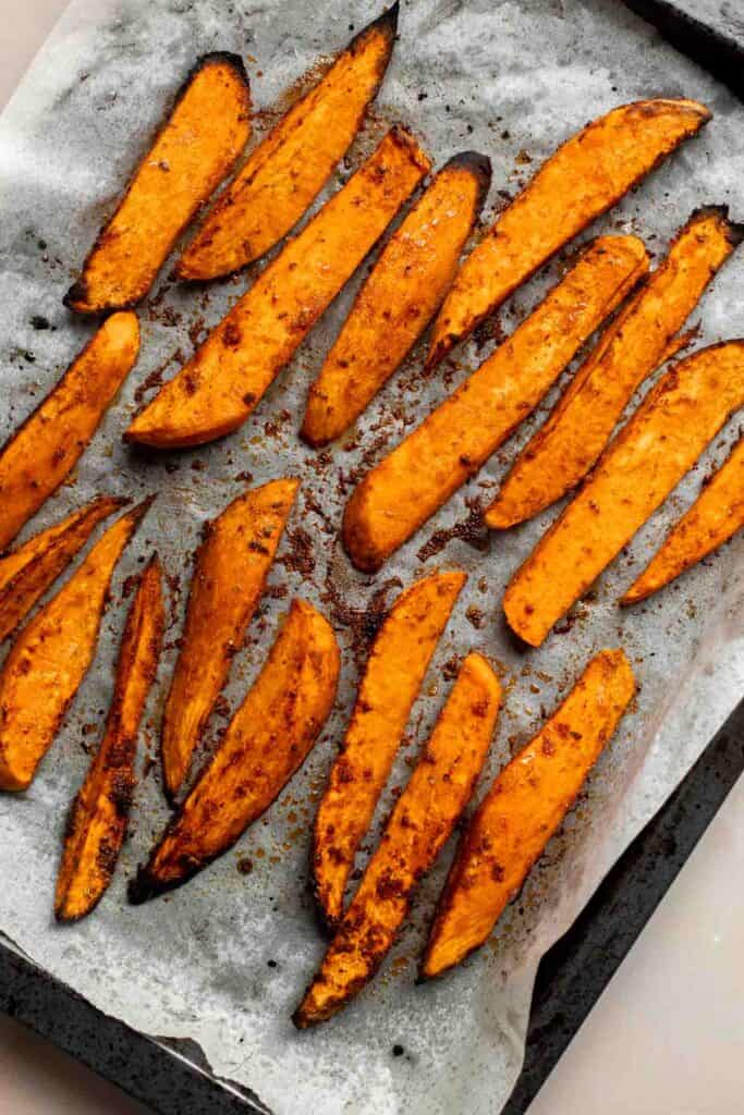Baked Sweet Potato Wedges are crispy, delicious, flavorful. Serve as an appetizer or side dish. They are salty, savory, and sweet, with a hint of spice. | aheadofthyme.com